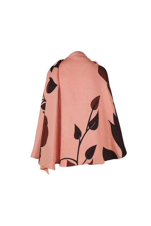 A peach pink cape featuring a dark brown floral and leaf pattern, displayed against a solid white background.