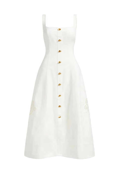 White maxi dress with gold buttons on a white background