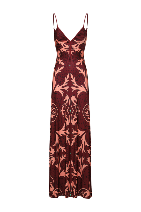 A floor-length spaghetti-strap dress in deep burgundy with a prominent coral-pink baroque floral pattern, shown against a plain white background.