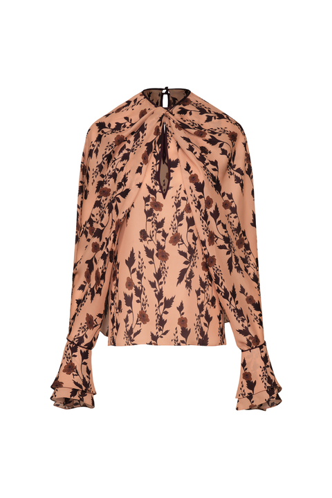 A long-sleeve blouse with a high gathered neckline, tie-front detail, and ruffled cuffs, featuring a brown floral print on a warm beige background.