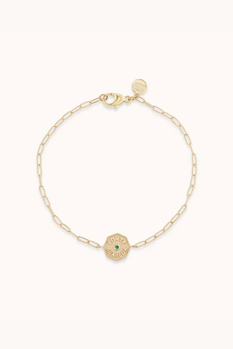 Yellow gold chain bracelet with small gold amulet with raised 'Porte Bonheur' and small emerald.