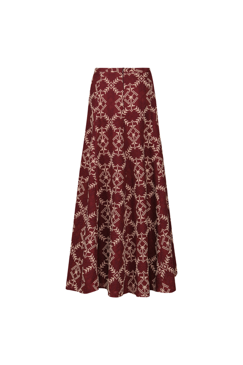 A burgundy patterned maxi skirt on a white background