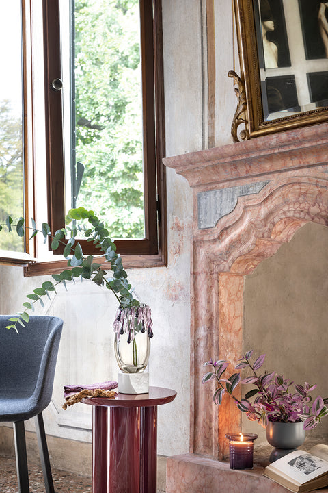 Murano glass vase filled with eucalyptus in beautiful home.