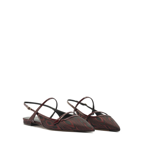 Pair of red and black patterned flats on a white background
