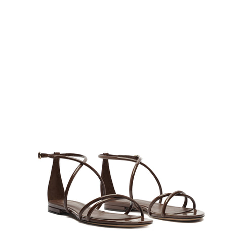 Pair of brown patent leather strappy sandals.