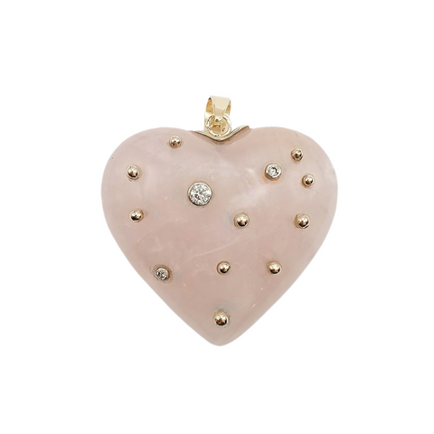 Heart-shaped rose quartz pendant with gold accents on a white background
