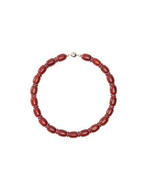 Red beaded necklace on a light gray background