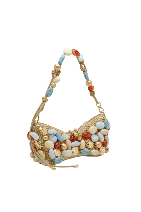 Gold handbag with colorful beads on a beige background from the side view.