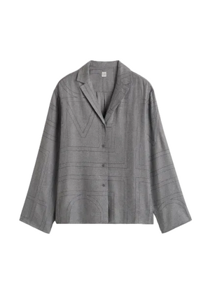 Gray flannel shirt with black contrast stitching design on a light gray background
