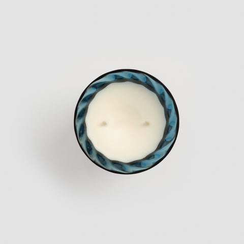 Bird eye view of the blue glass candle with two wicks.