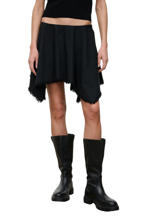 A model wearing a black asymmetrical mini skirt with a raw, frayed hem, paired with black knee-high leather boots against a plain white background.