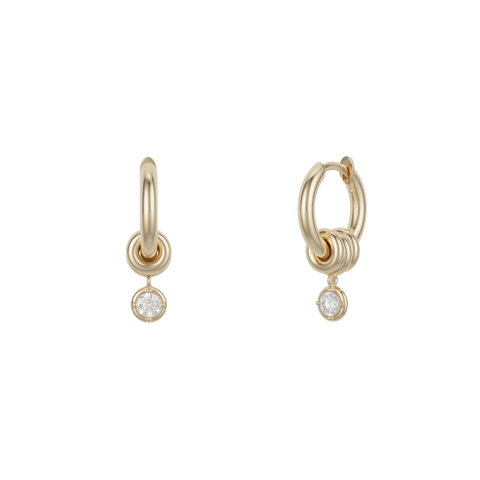 Ghost image of 18k yellow gold mini hoop earring that features three 18k yellow gold annulets, one with a round white diamond charm.