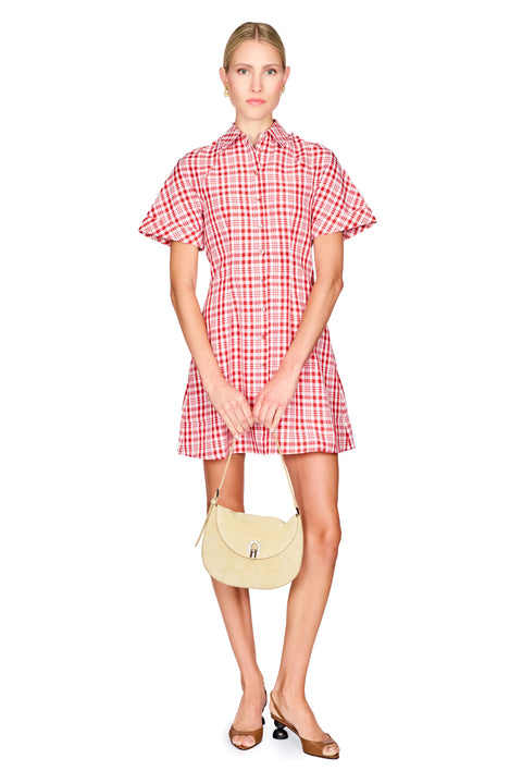Woman wearing a red and white checkered dress on a white background