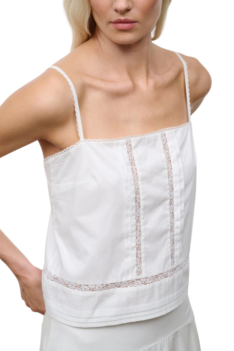 Close-up of an ivory sleeveless top with embroidery and lace