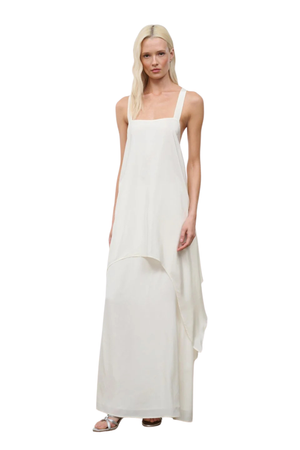 Woman wearing a long white silk dress on a white background
