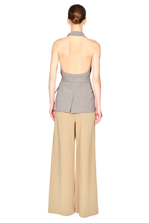 A model shown from the back wearing a sleeveless halter-style top with a gray and white pinstripe pattern and beige wide-leg trousers, set against a plain white background.