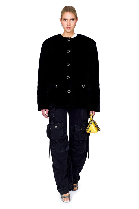 Front facing stance of quilted velvet evening jacket with gold buttons and cargo pants