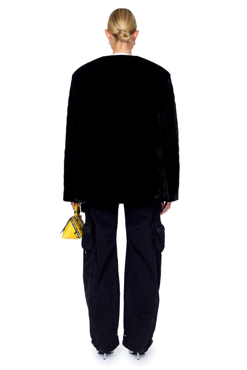 Back view of quilted velvet evening jacket with gold buttons and cargo pants