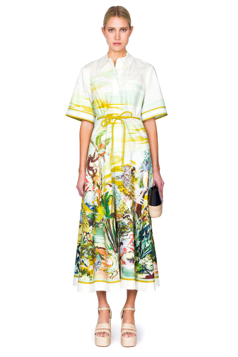 Woman wearing a floral dress with a yellow waist tie on a white background