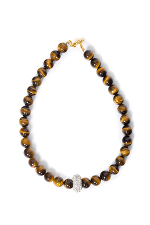 Necklace with tiger eye beads and strass charm with a gold clasp on a white background