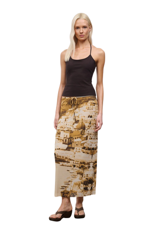 Woman wearing a patterned city view skirt on a white background