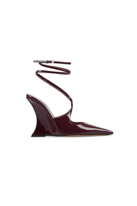 Burgundy patent leather slingback heel with wrap around ankle straps and a wedge heel. 