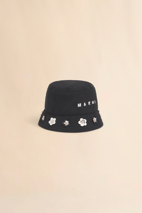 Black bucket hat with floral embellishments and 'Marni' branding on a beige background