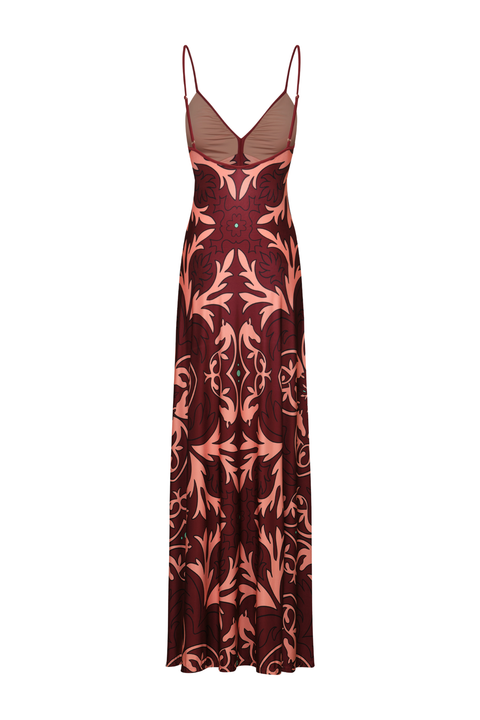 A floor-length dress with thin straps, a deep V-neckline, and a symmetrical floral damask pattern in dusty rose and deep burgundy, shown against a plain white background.