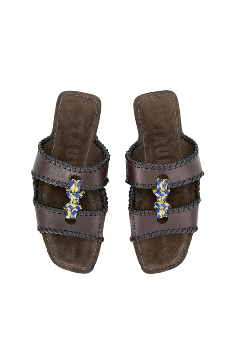 A brown slide-on sandal with a blue tie in the middle