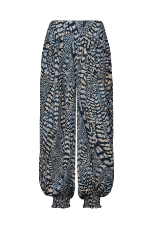 A pair of loose, balloon-style pants with an all-over abstract animal-inspired print in black, gray, and beige, featuring gathered cuffs at the ankles.