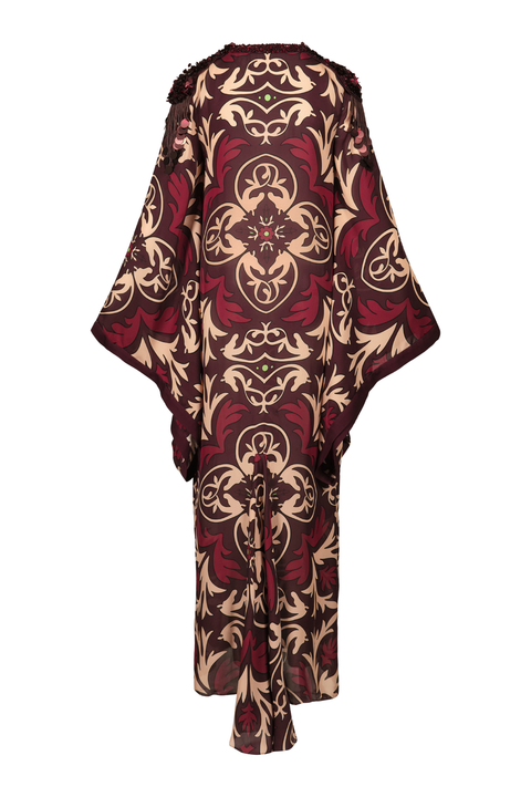 A long, wide-sleeved kaftan dress featuring an intricate baroque-style damask pattern in deep burgundy red and beige, shown from the back against a plain white background.