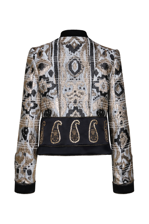 A women's cropped jacket with a black, beige, and gray geometric patterned body, featuring a wide black waistband embellished with three large paisley motifs outlined in gold beadwork, and solid black ribbed cuffs and collar.