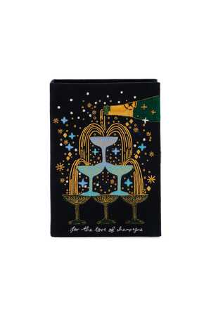 A black book clutch featuring a whimsical cocktail-themed illustration with three blue and gold martini glasses, a green and gold bottle, and white script text reading 'for the love of champagne' at the bottom.