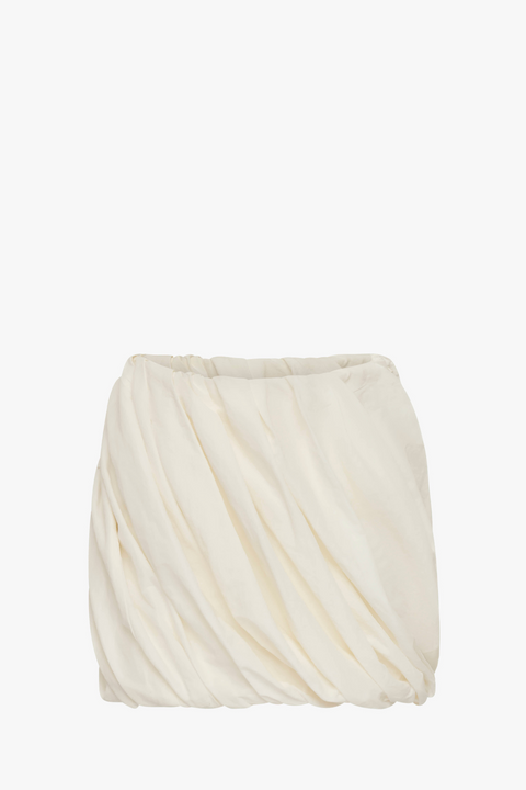 White mini skirt with twist detail throughout.