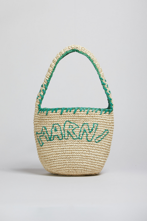 Woven basket with green handle and 'Marni' branding on a light gray background