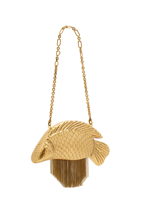 A gold fish-shaped shoulder bag with a textured scale pattern and dangling chain fringe, suspended from a delicate gold chain strap against a plain white background.