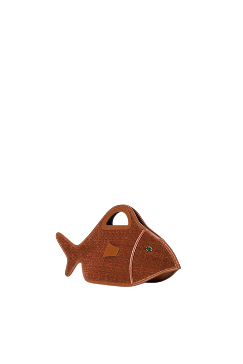 A brown fish-shaped handbag with a textured leather exterior, a top handle, and a small green eye detail, shown on a plain white background.