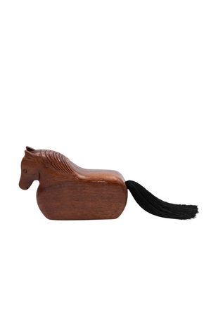 A small carved wooden horse figurine with a black tail, shown in profile against a plain white background.