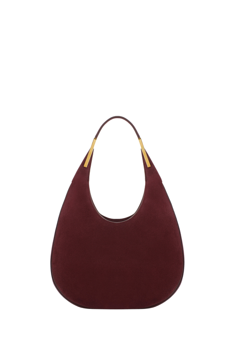 Maroon suede handbag with gold accents on a white background