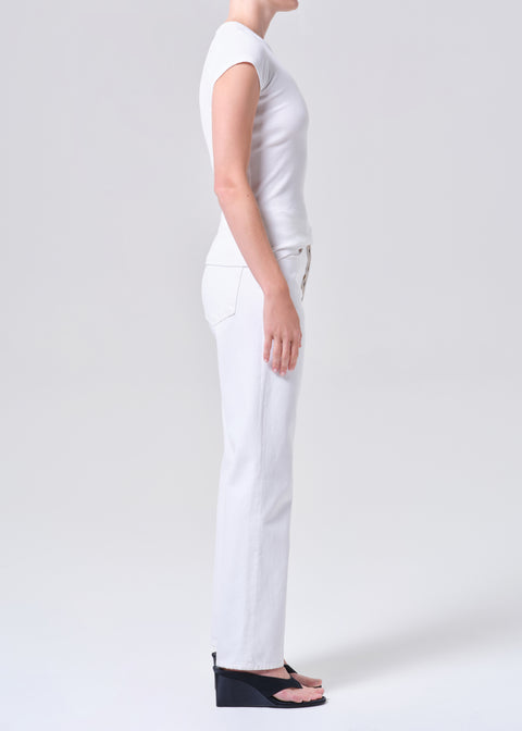 Person wearing a white t-shirt and white, mid-rise, straight-leg jeans on a white background facing forward from the side