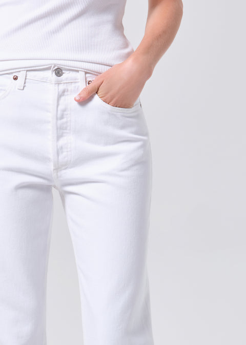 Person wearing a white t-shirt and white, mid-rise, straight-leg jeans on a white background facing forward zoomed in 