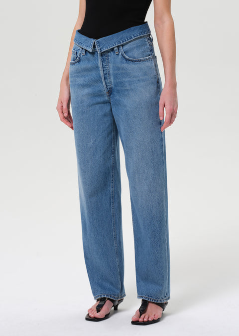 Closer look at women in blue jeans with fold over at waist.