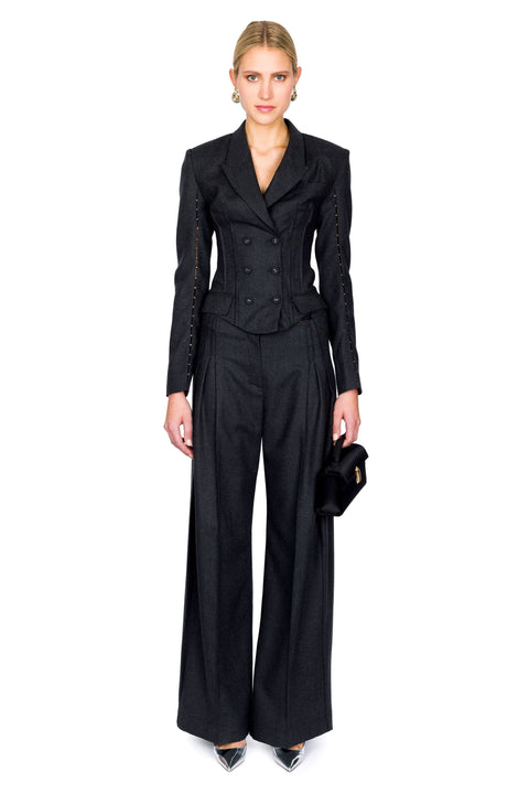Gray double breasted, long-sleeve top paired with matching trousers that are pleated down the middle