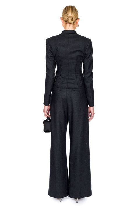 Back view of gray double breasted, long-sleeve top paired with matching trousers that are pleated down the middle