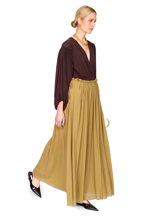 Model walking in brown long sleeve bodysuit and tulle skirt.