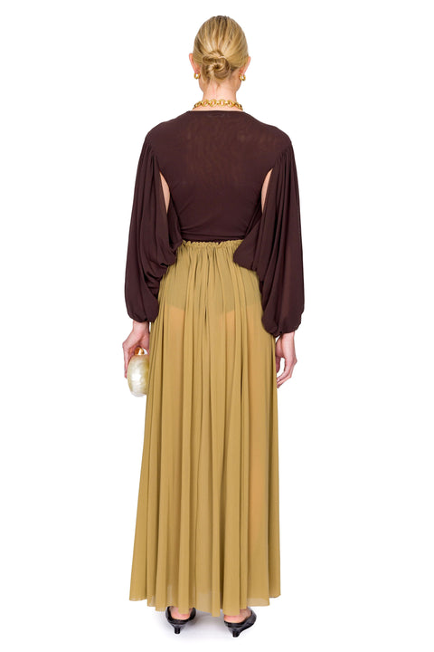 Back of model in brown tulle bodysuit and maxi skirt.