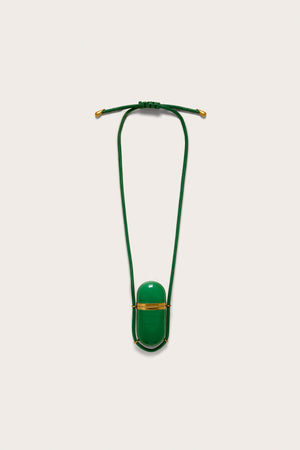 A green, functional amulet pendant with gold hardware on a green leather cord necklace. 