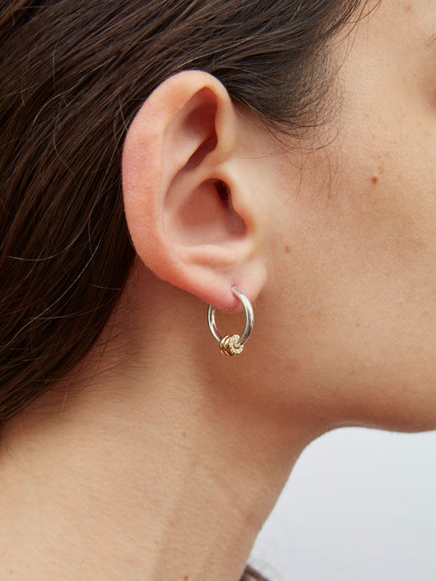 Close up of a woman wearing a Spinelli Kilcollin Ara SG Deux earring. 