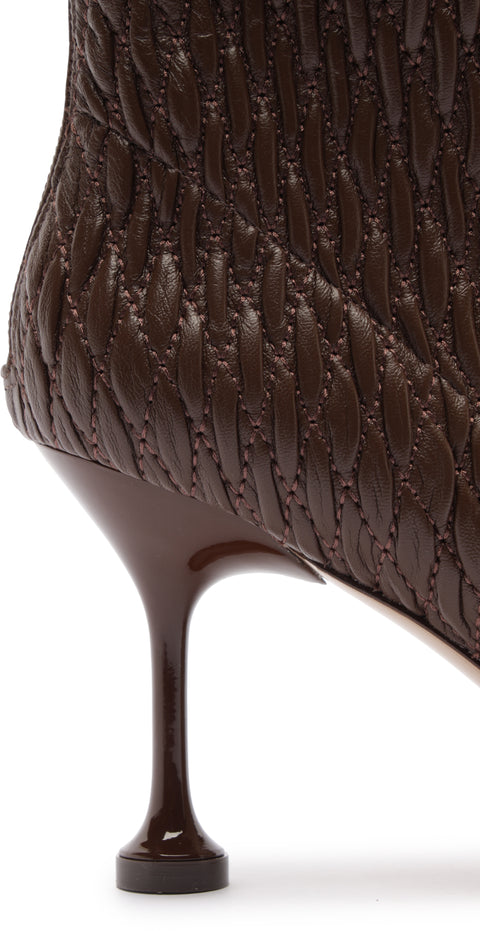 Brown textured high-heeled shoe on a white background