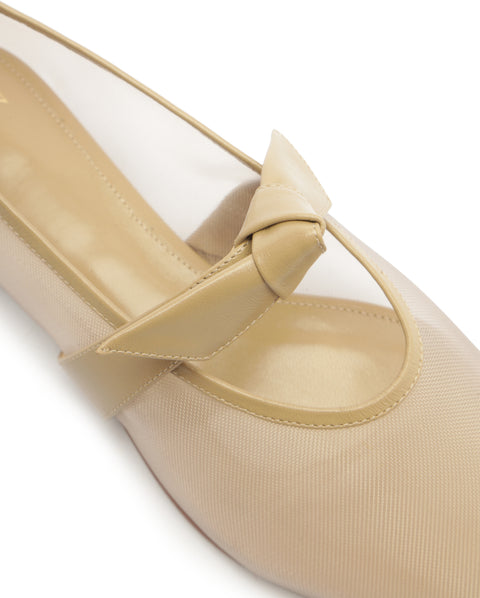 Beige shoe with a bow detail on a white background